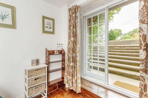 a living room with a large window at The Garden Flat Ardullie in Ardullie