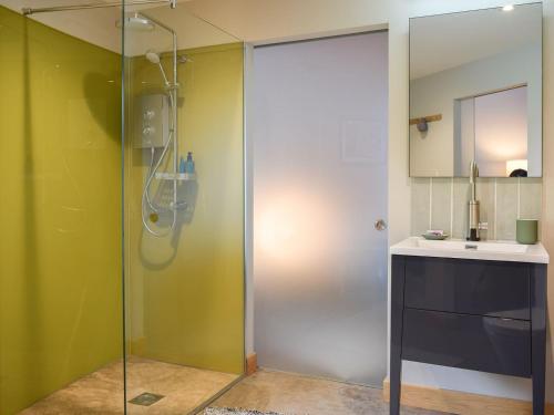 a shower with a glass door in a bathroom at The Roondie in Ladybank