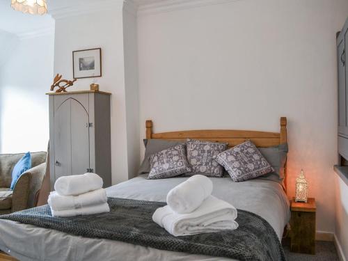 a bedroom with a bed with towels on it at Chapel Farm Cottage in Wetwang