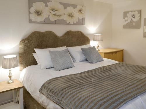 a bedroom with a bed with two tables and two lamps at Runhead Forge in Ryton