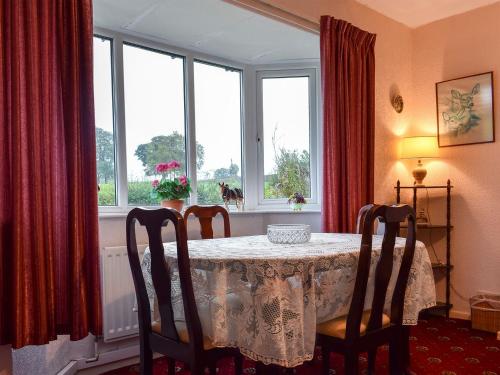 a dining room with a table and a window at Penn Hill View in Aysgarth