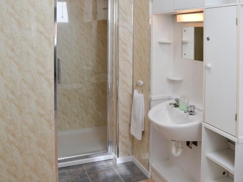 a bathroom with a shower and a sink at Rosemarys Sea View in Bacton