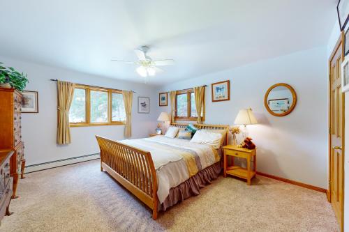a bedroom with a bed and a ceiling fan at Ski Bike the East in Stowe