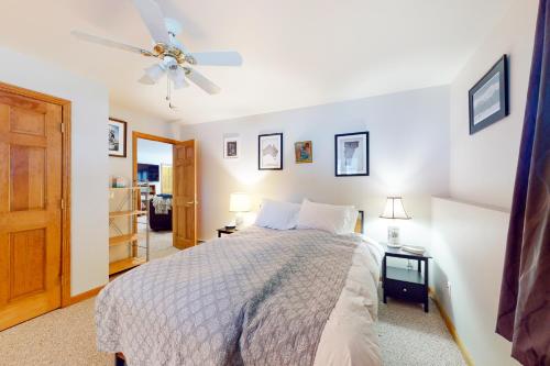 a bedroom with a bed and a ceiling fan at Ski Bike the East in Stowe