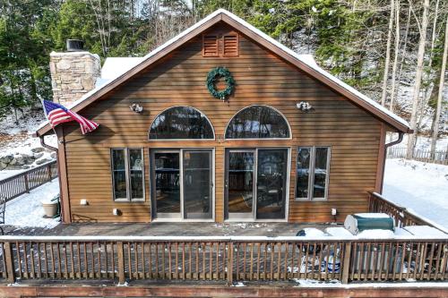 a house with a flag on the front of it at Ski Bike the East in Stowe