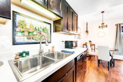 a kitchen with a stainless steel sink and wooden cabinets at Piestewa Peak Vista in Phoenix