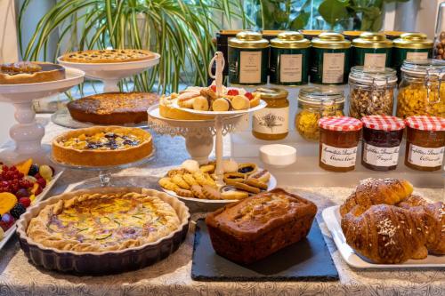 a table filled with pies and other food items at Langhe Country House in Neive