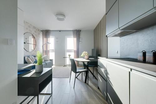 a kitchen with a table and a dining room at Apartamenty stadion narodowy in Warsaw