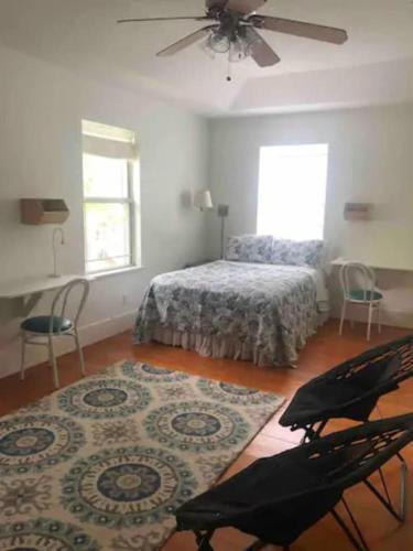 a bedroom with a bed and a ceiling fan at Luxurious indoor/outdoor Family Paradise in downtown St Augustine in St. Augustine