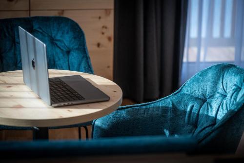 a laptop computer sitting on top of a wooden table at Naturhotel Tandler in Sankt Jakob in Defereggen