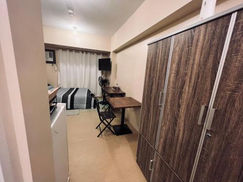 a room with a bed and a desk and a closet at B Avida Tower in Iloilo City