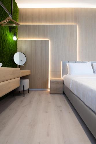 a bedroom with a white bed and a desk and a bed sidx sidx at Incanto Boutique Suites - Neos Kosmos in Athens