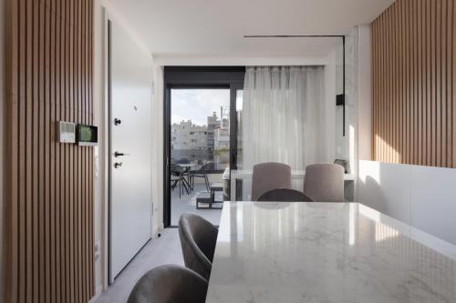 a dining room with a table and chairs at Incanto Boutique Suites - Neos Kosmos in Athens