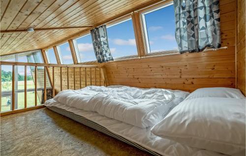 a large bed in a room with windows at Nice Home In Kolding With House A Panoramic View in Kolding