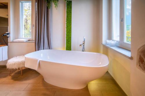 a white bath tub in a bathroom with a window at Langhe Country House in Neive