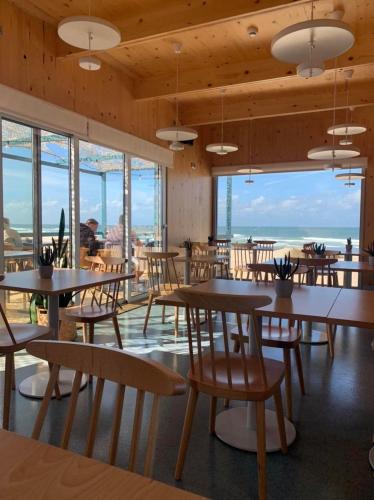 a restaurant with tables and chairs and a view of the ocean at Casa d´Avó Dalina in Figueira da Foz