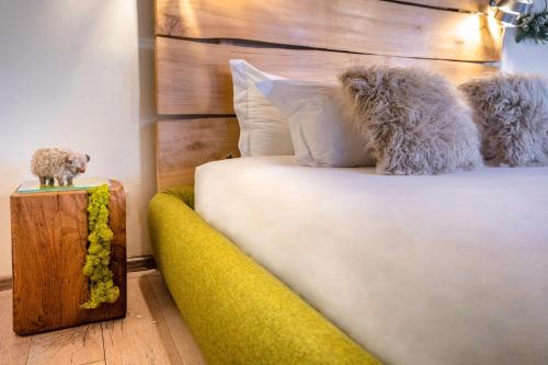 a bedroom with a white bed and a yellow couch at Langhe Country House in Neive