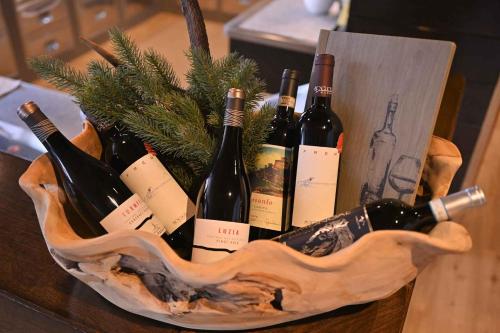 a basket of wine bottles on a table at Hotel Toblacherhof in Dobbiaco
