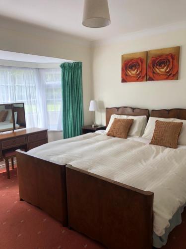 a bedroom with a large bed and a piano at Fairways B&B in Westmeath