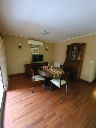 a living room with a large table and chairs at Departamento Caseros in Salta