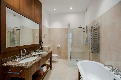 a bathroom with two sinks and a shower at Residence 1898 in Warsaw