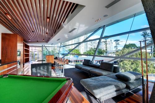
a living room filled with furniture and a large window at Reflection on the Sea in Gold Coast
