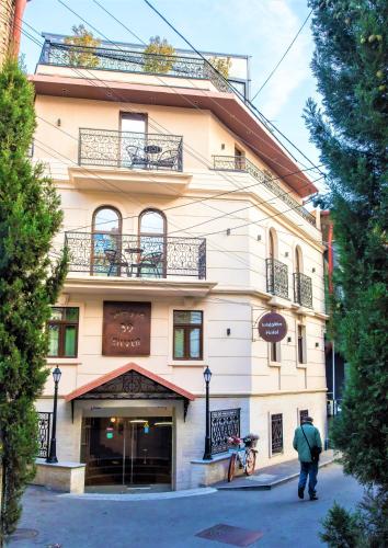 a man standing in front of a building at Silver 39 Corner Hotel in Tbilisi City