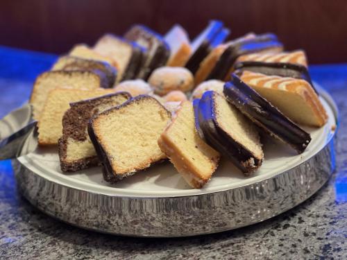 a plate of different types of desserts on a table at Gästehaus Kral in Erlangen