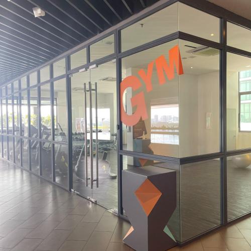 an office with a synergy sign on the glass wall at Atria SOFO Suites By Stay In in Petaling Jaya