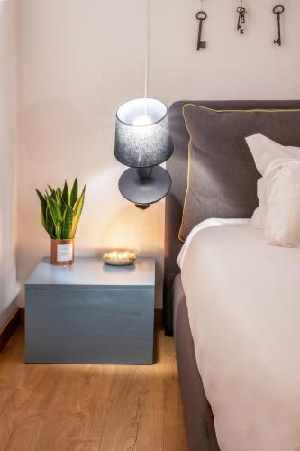 a bedroom with a bed and a lamp on a table at Langhe Country House in Neive