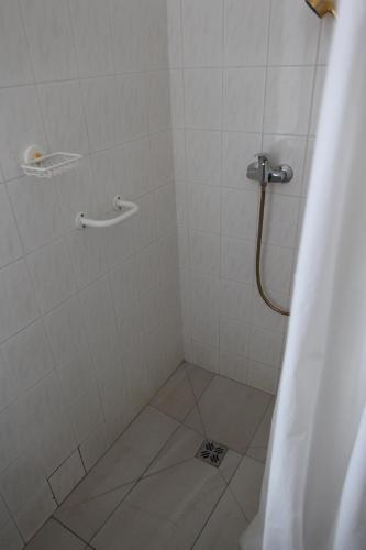 a bathroom with a shower with a shower curtain at Hotel Skála in Malá Skála