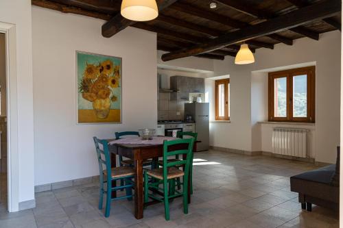 a kitchen and dining room with a table and chairs at CASALE DEI PRIORI in Rocca Massima