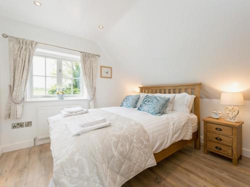 a bedroom with a large bed and a window at The Apple Loft in Mickleton