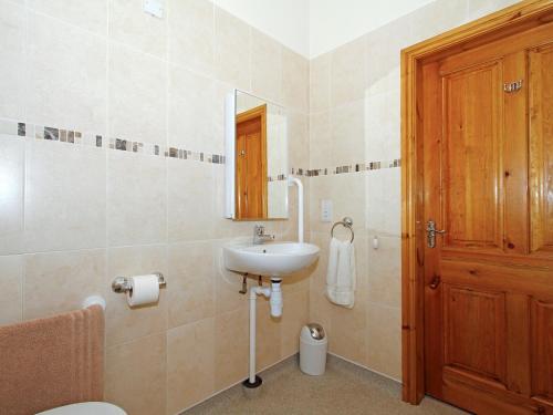 a bathroom with a sink and a toilet and a mirror at Stables in North Somercotes