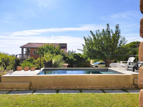a swimming pool in a yard with a house at Cilento Loft with Private Pool in Ascea