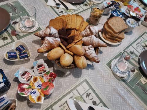 a table with a bunch of bread and pastries on it at Il Colibrì Bed&Breakfast in Leno