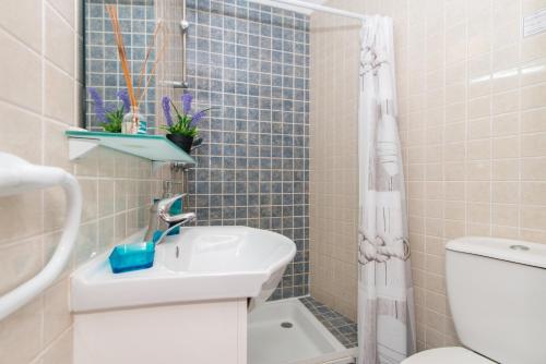 a bathroom with a sink and a toilet and a shower at Casa Florinda By ALGARTUR in Tavira