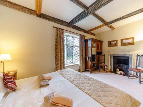 a bedroom with a large bed and a fireplace at Sir Henry Sidney-ukc4033 in Ludlow