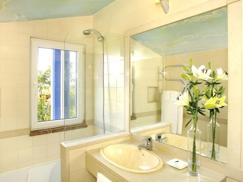 a bathroom with a sink and a vase of flowers at Stunning Lagos Villa 10 Bedrooms Villa Lacuna Deluxe Private Pool and Jacuzzi Algarve in Lagos
