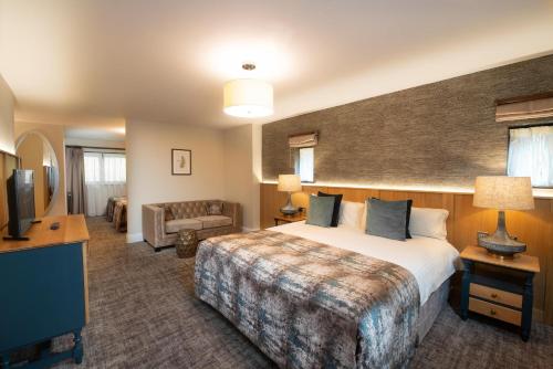 a hotel room with a bed and a television at Boringdon Hall Hotel and Spa in Plymouth