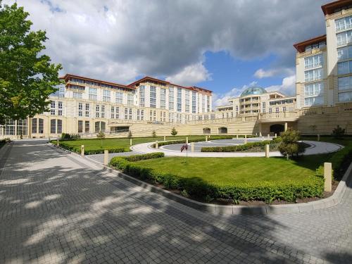 a large building with a courtyard in front of it at ARDEN PALACE Medical Resort & SPA in Satanov