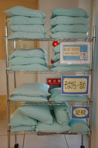 a rack filled with blue pillows in a store at Hotel Los Inn Kochi in Kochi