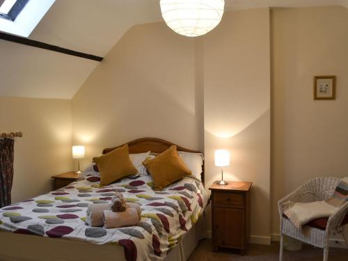 a bedroom with a bed with a teddy bear on it at Grangemoor Barn in Rothley