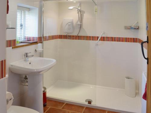 a bathroom with a shower and a sink and a shower at The Stables in Elmstone