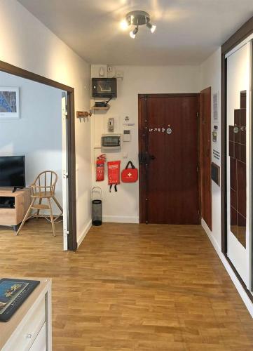 a living room with a wooden floor and a door at Reims Saint-Remi in Reims