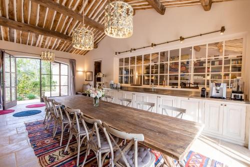 a kitchen with a large wooden table and chairs at Château de Berne in Lorgues