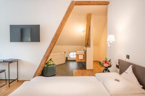 a hotel room with a bed and a television at Villa Waldkönigin in San Valentino alla Muta