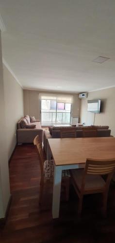a living room with a table and a couch at Departamento Caseros in Salta