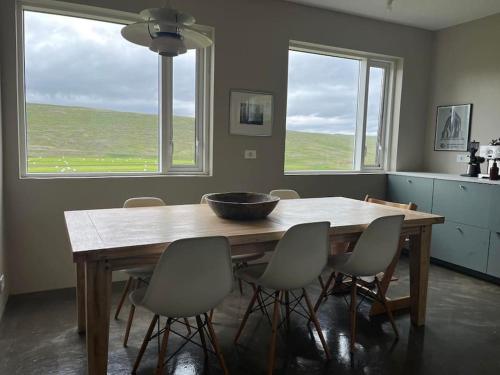 a dining room table with chairs and a bowl on it at Óspaksstaðir- New Renovated Farm in Hrútafjörður in Staður