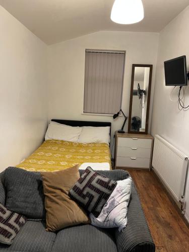 a bedroom with a bed and a couch in it at Haggai COMFORT SUITES in Parkside